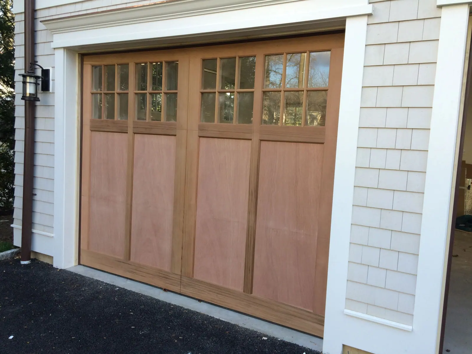 A stained cedar double carriage door installed by Apex Door in Westchester County