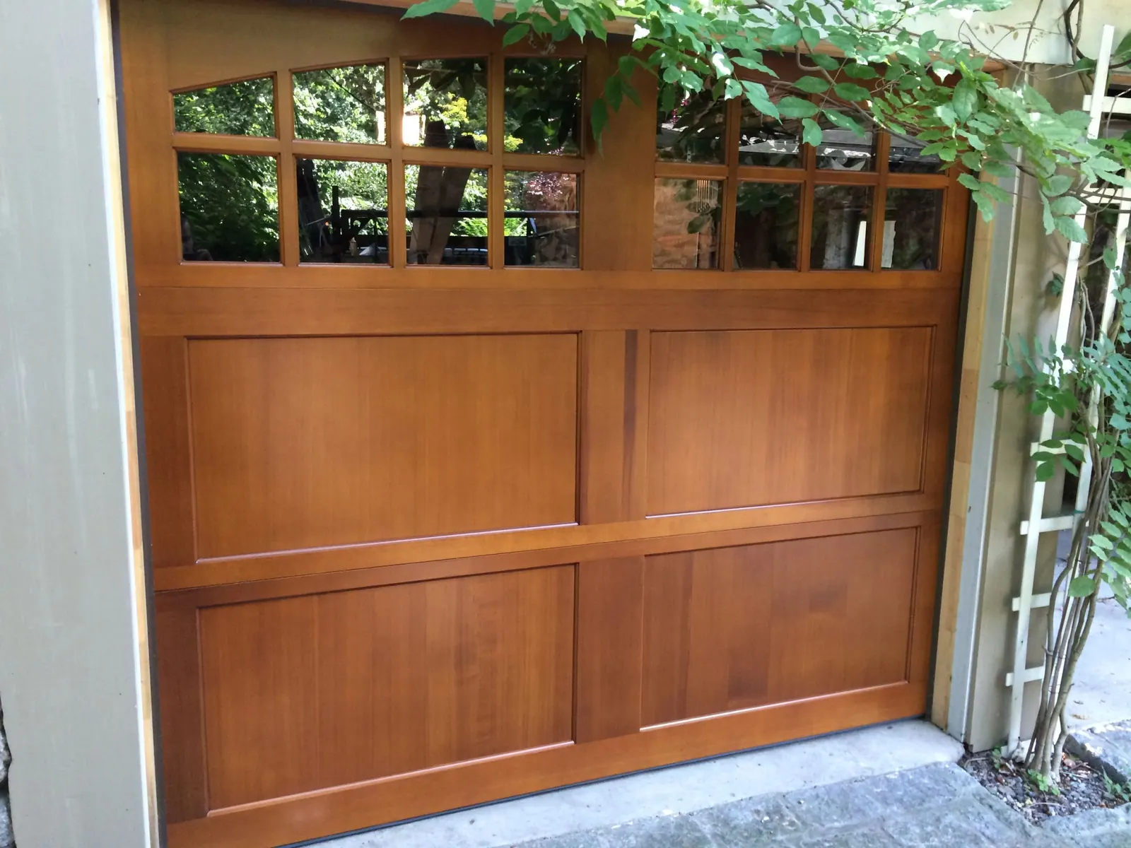 A stained cedar-wood carriage door installed on a Westchester home